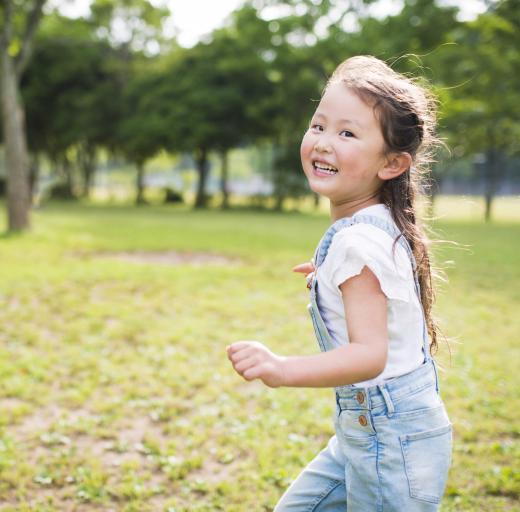 Een jong meisje is buiten in schone lucht aan het rennen