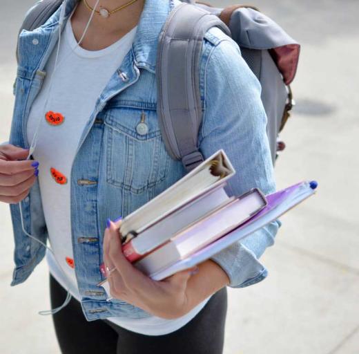 Een student draagt boeken