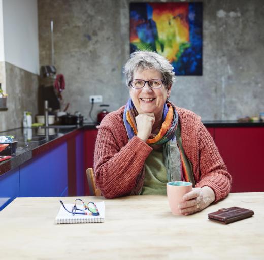 Vrijwilliger Elly Janssen zit aan tafel