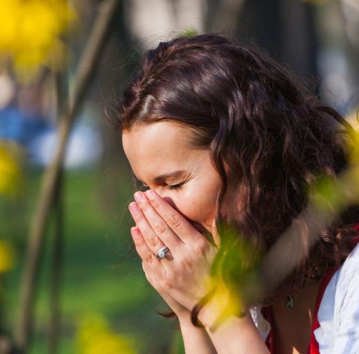 Vrouw niest door hooikoorts