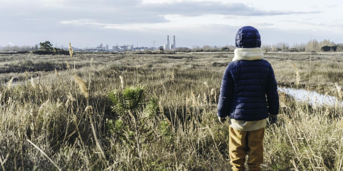 Foto kind kijkend naar industrieen